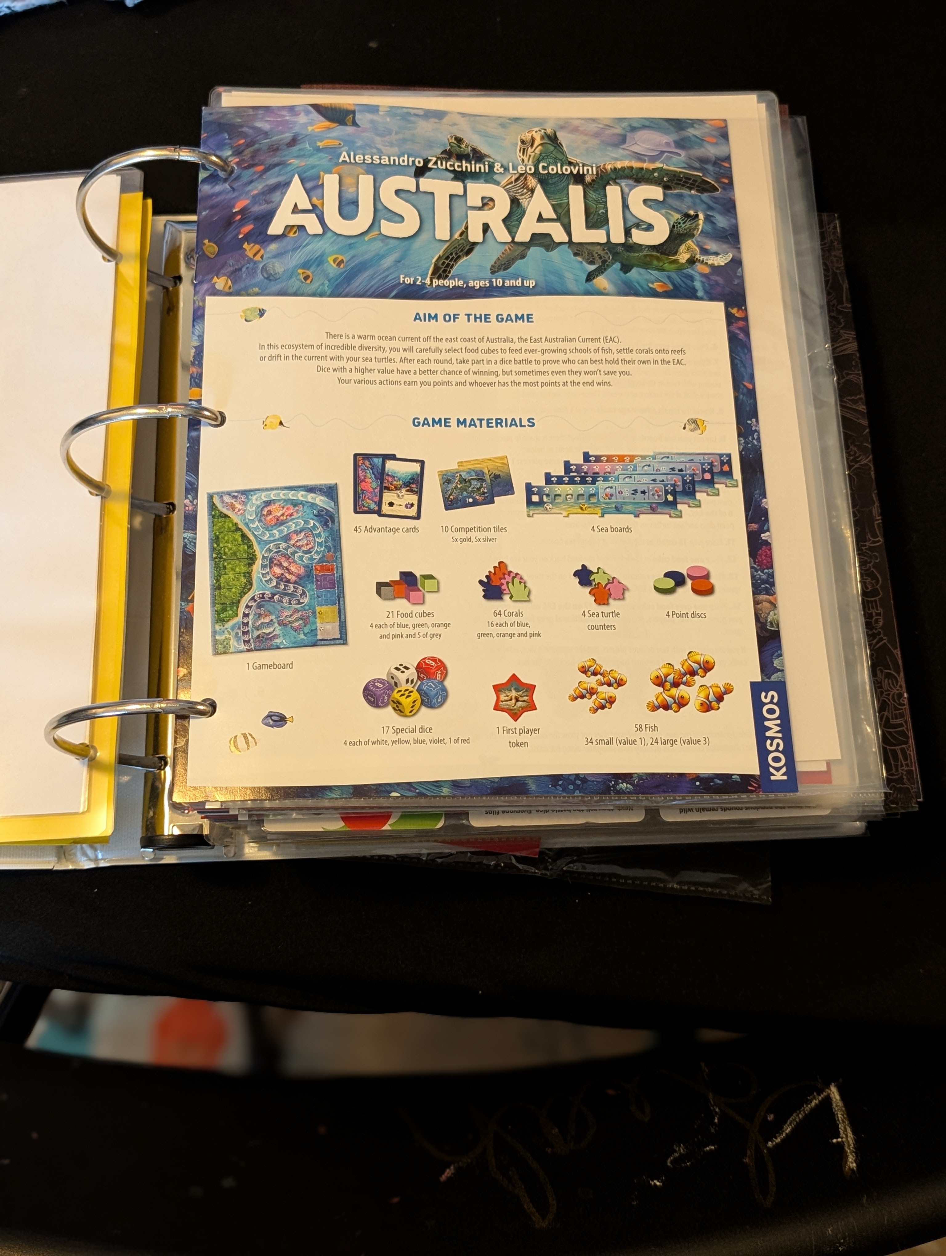A binder page protector holding the rulebook for the board game Australis