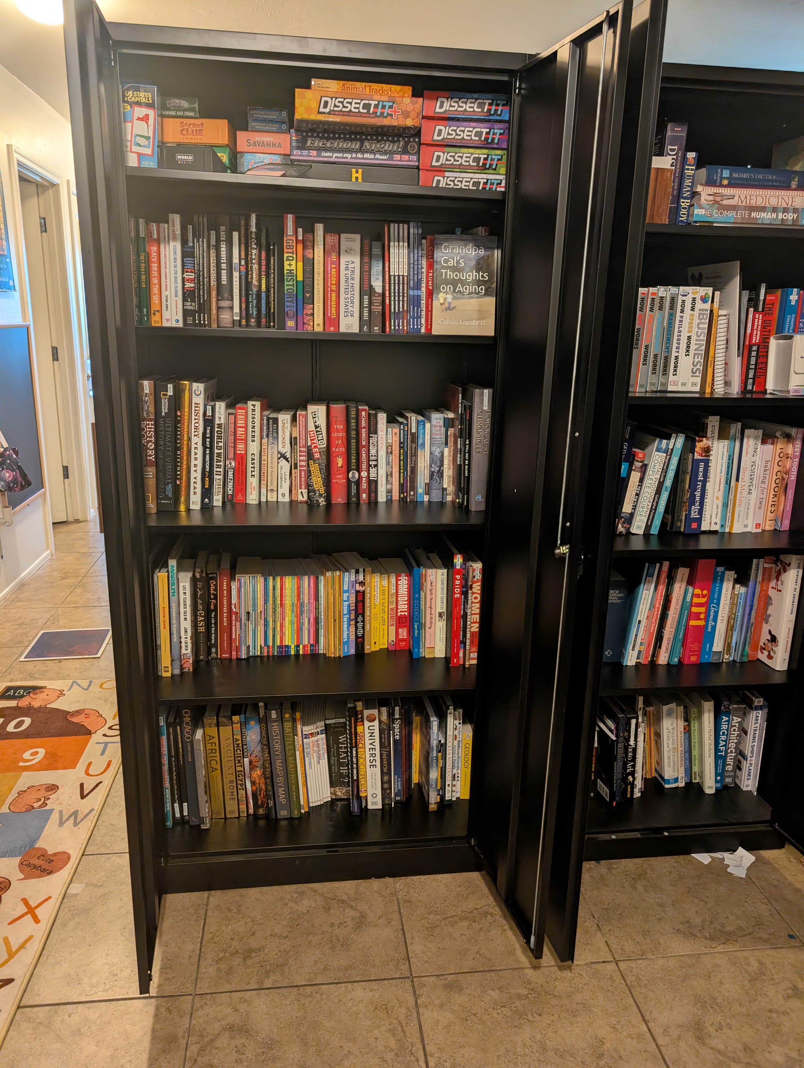 A bookshelf packed with history, science, and dissection kits